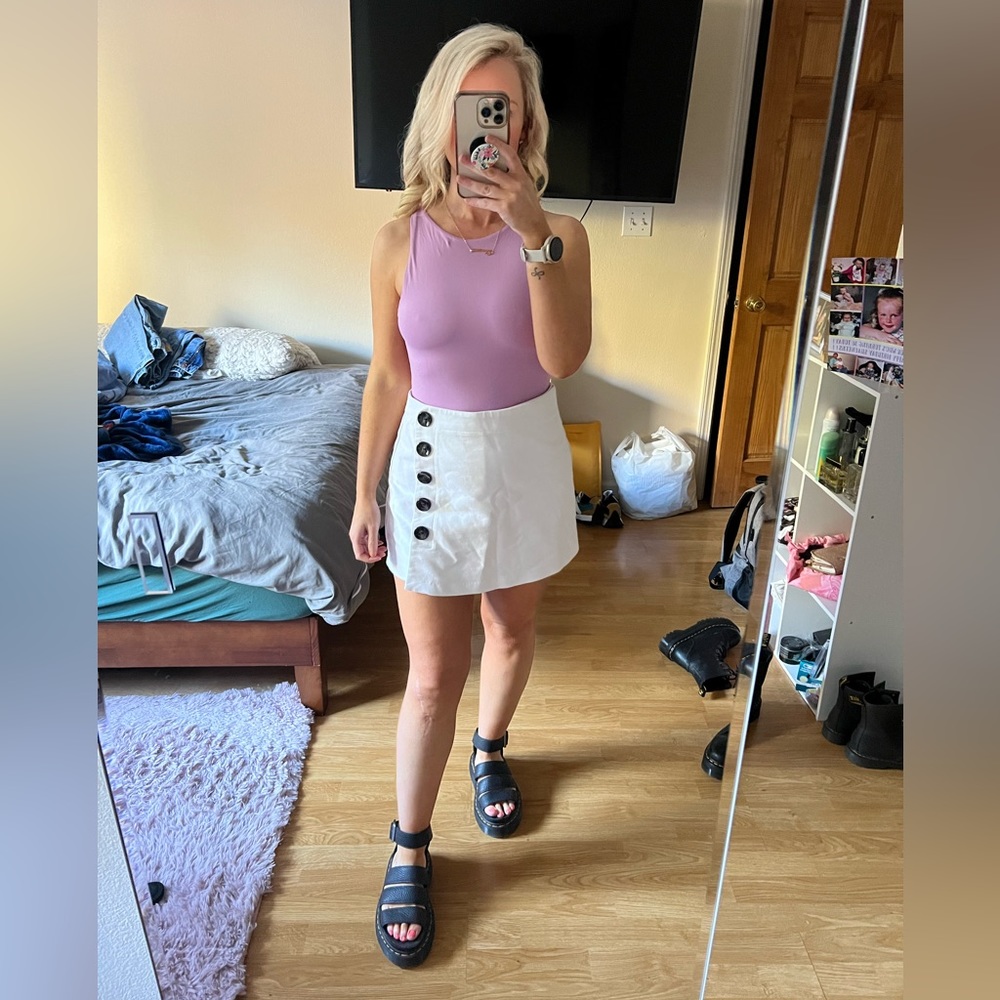 White Stradivarius skorts with black buttons.